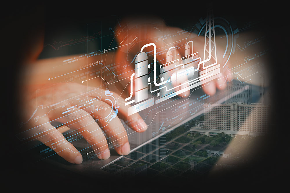 Engineer using laptop with chemical plant drawing overlay and industrial facility background
